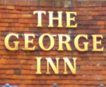 The pub sign. The George Inn, Robertsbridge, East Sussex