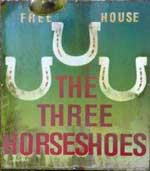 The pub sign. Three Horseshoes, Elsted, West Sussex