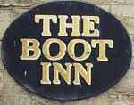 The pub sign. The Boot Inn, Tisbury, Wiltshire