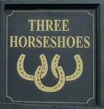 The pub sign. Three Horseshoes, Roydon, Norfolk