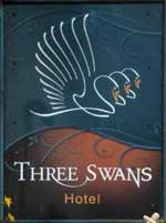 The pub sign. Three Swans Hotel, Hungerford, Berkshire