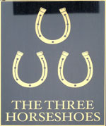 The pub sign. The Three Horseshoes, Briston, Norfolk