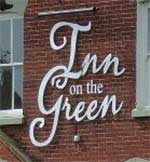 The pub sign. Inn on the Green, New Buckenham, Norfolk