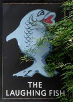 The pub sign. The Laughing Fish, Isfield, East Sussex
