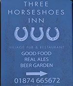 The pub sign. Three Horseshoes Inn, Groesffordd, Powys